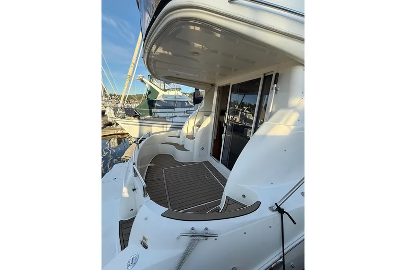 Slide: The Image of 2007 Meridian 341 Sedan yacht with sleek white exterior and spacious deck at marina. - 2