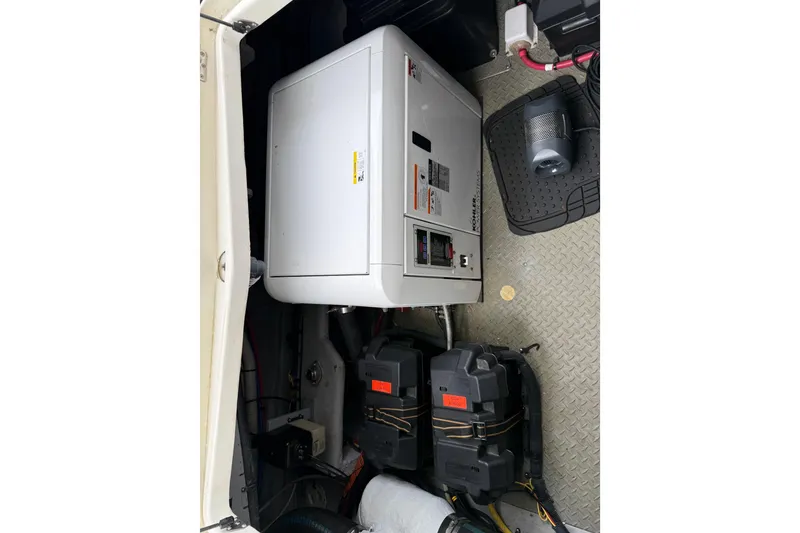 Slide: The Image of Engine compartment of a 2007 Meridian 341 Sedan with generator and battery setup. - 23