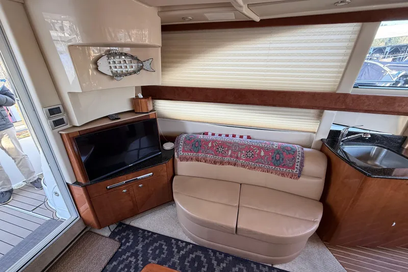 Slide: The Image of Interior of 2007 Meridian 341 Sedan yacht with TV, sofa, and kitchenette. - 4