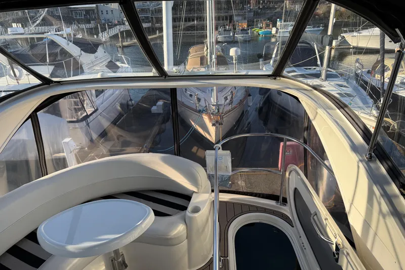 Slide: The Image of 2007 Meridian 341 Sedan yacht interior with marina view, featuring seating and table. - 8