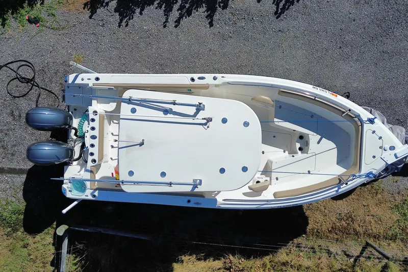 Slide: The Image of Overhead view of 2020 Sailfish 242 CC boat with dual engines on gravel. - 24