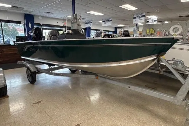 Slide: The Image of 2026 Lund 1600 Fury SS boat displayed indoors on a trailer. - 1