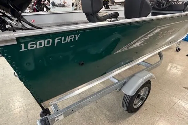 Slide: The Image of 2026 Lund 1600 Fury SS boat on trailer, green exterior, showroom display. - 3