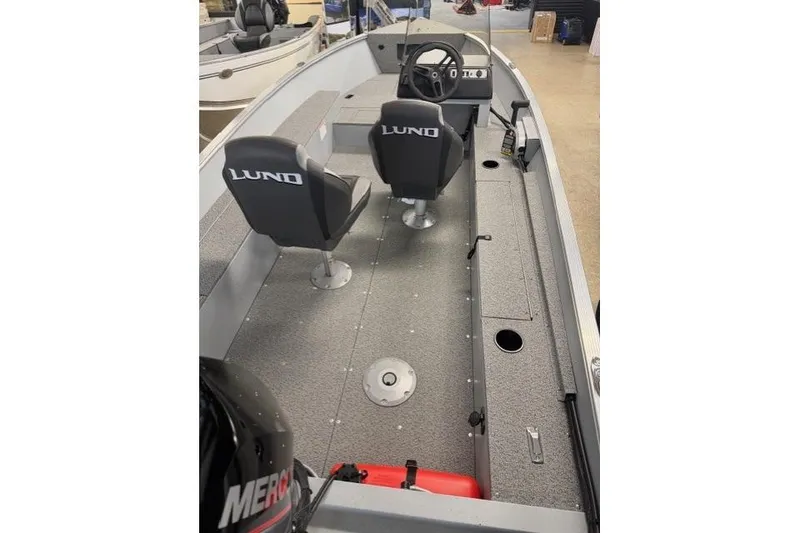 Slide: The Image of 2026 Lund 1600 Fury SS boat interior with two seats and steering console. - 7