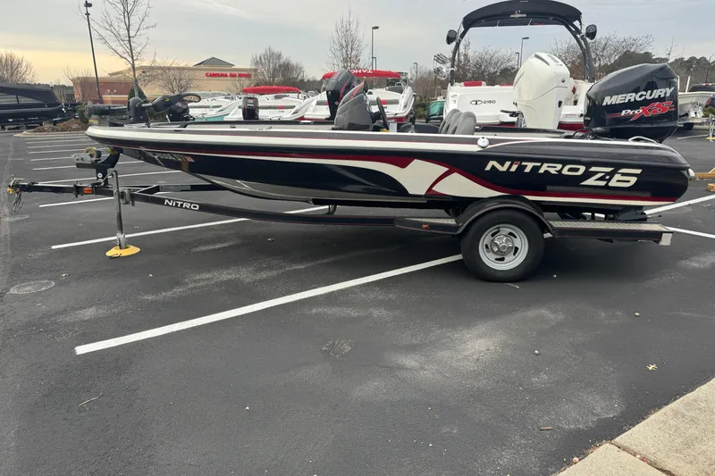 The Image of 2013 Nitro Z-6 boat with Mercury Pro XS engine in parking lot. - 0