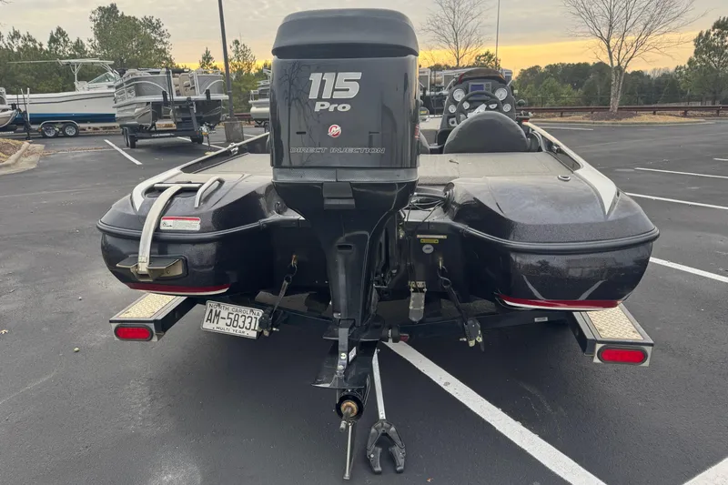 Slide: The Image of 2013 Nitro Z-6 boat with 115 Pro motor in parking lot. - 2