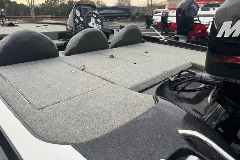 Slide: The Image of 2013 Nitro Z-6 boat with spacious deck and powerful engine in a parking lot. - 4