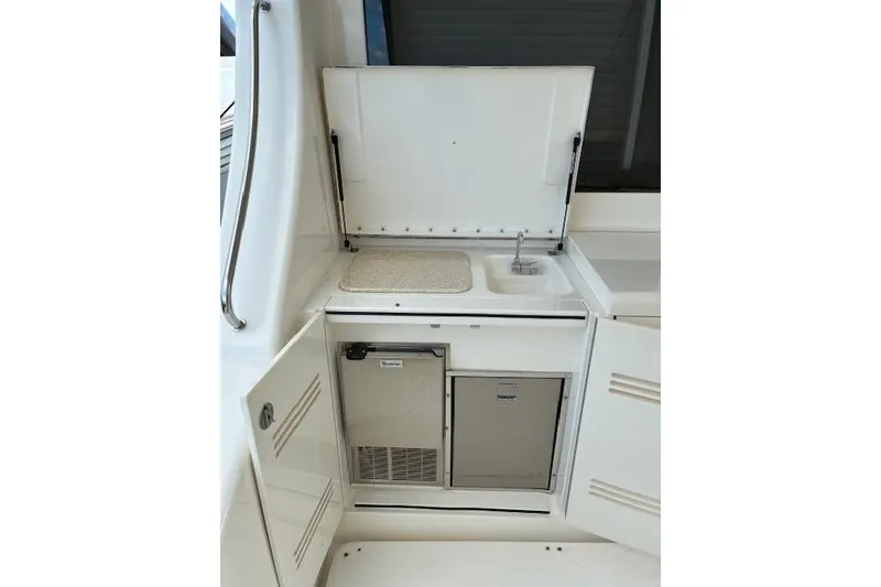 Slide: The Image of 2004 Silverton 48 Convertible yacht interior with open storage compartments. - 16