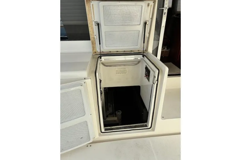 Slide: The Image of Interior view of 2004 Silverton 48 Convertible yacht with cream seating and windows. - 17