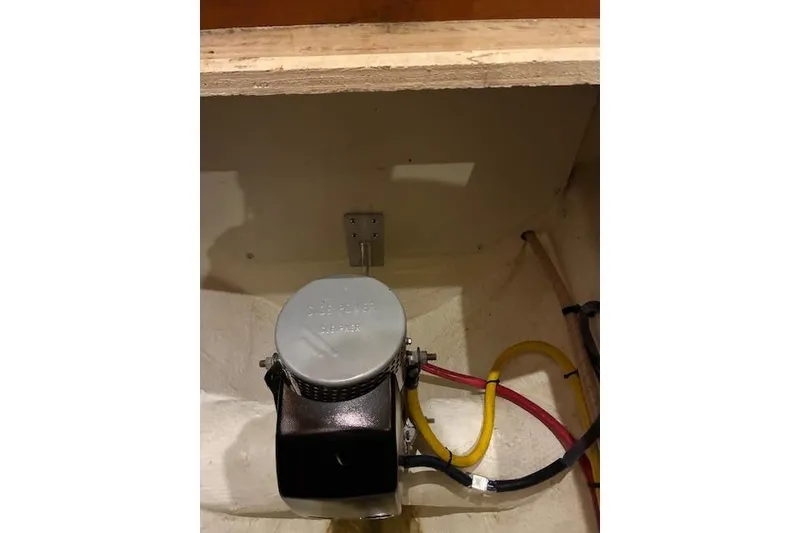 Slide: The Image of 2004 Silverton 48 Convertible yacht kitchenette with sink and storage compartments. - 25