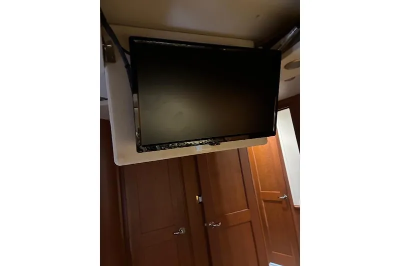 Slide: The Image of Carpeted stairs with a wooden outlet cover on a 2004 Silverton 48 Convertible. - 45