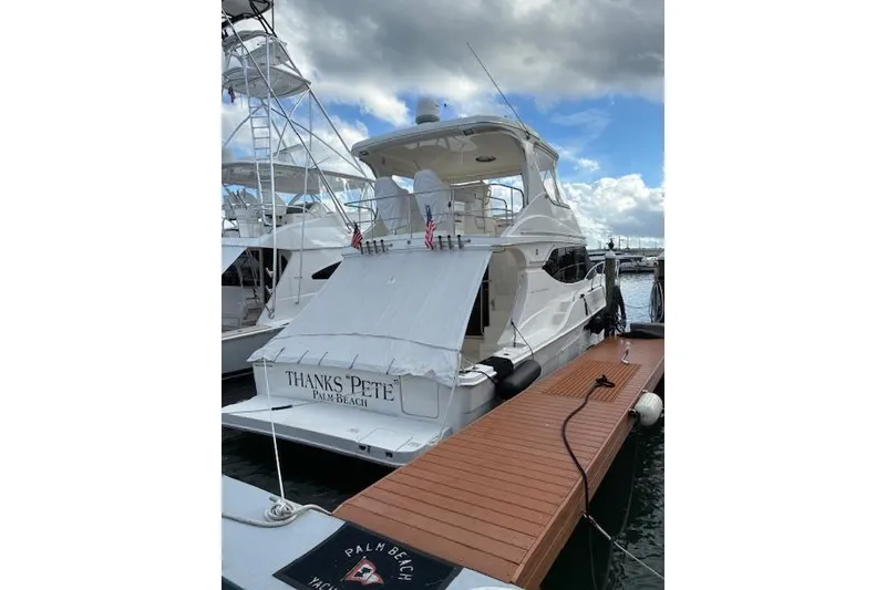 Slide: The Image of 2004 Silverton 48 Convertible yacht docked at marina, named "Thanks Pete" from Palm Beach. - 5