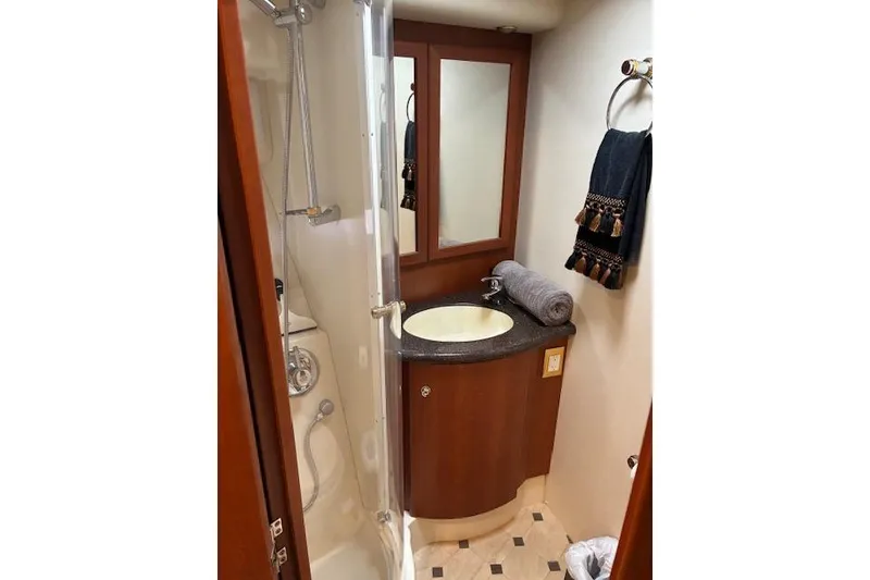 Slide: The Image of Luxurious bedroom interior of 2004 Silverton 48 Convertible yacht with ornate bedding. - 53