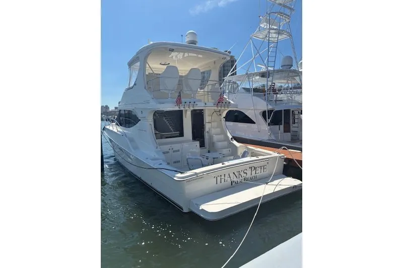 Slide: The Image of 2004 Silverton 48 Convertible yacht docked at marina, rear view. - 6