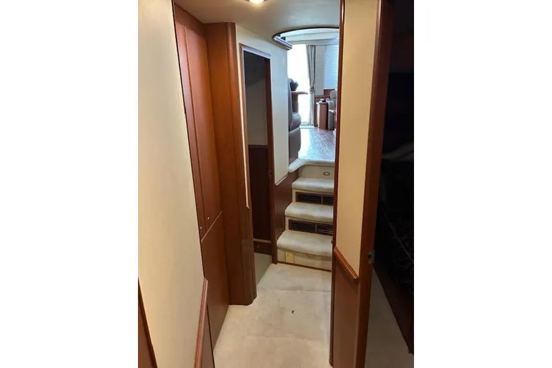 Slide: The Image of Interior hallway of 2004 Silverton 48 Convertible yacht with wooden cabinetry and carpeted stairs. - 63