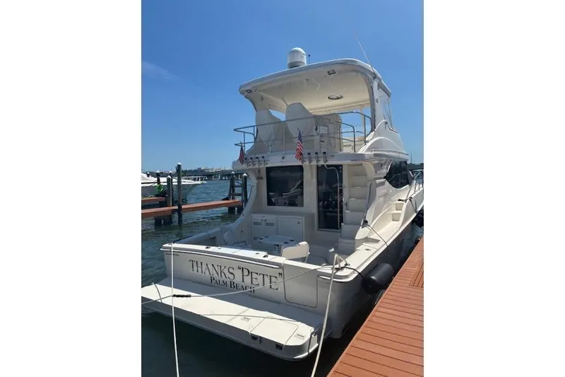 Slide: The Image of 2004 Silverton 48 Convertible yacht docked, rear view with "Thanks Pete" text. - 7