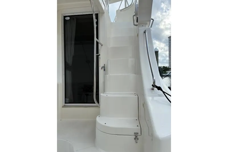 Slide: The Image of 2004 Silverton 48 Convertible yacht docked at marina under clear sky. - 8