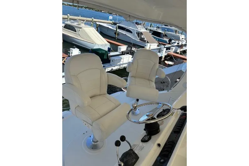 Slide: The Image of 2004 Silverton 48 Convertible yacht docked, featuring spacious deck and elegant design. - 9