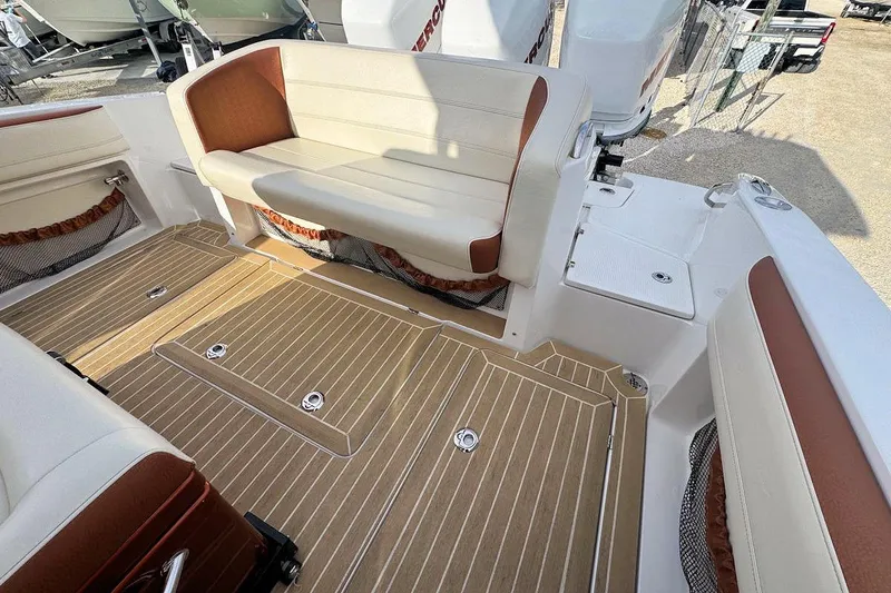 Slide: The Image of 2016 Nor-Tech 340 Sport Center Console with tan and white seating and deck. - 10