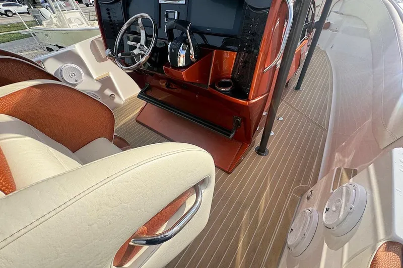 Slide: The Image of 2016 Nor-Tech 340 Sport Center Console interior with steering wheel and seating. - 14