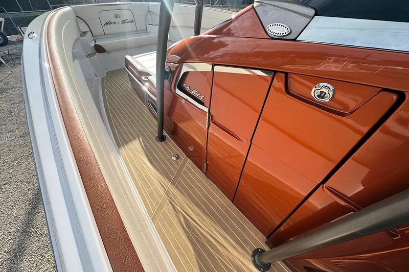 Slide: The Image of 2016 Nor-Tech 340 Sport Center Console with sleek orange detailing and spacious seating. - 23