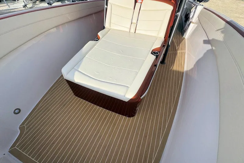 Slide: The Image of 2016 Nor-Tech 340 Sport Center Console with cushioned seating and wood-patterned flooring. - 26