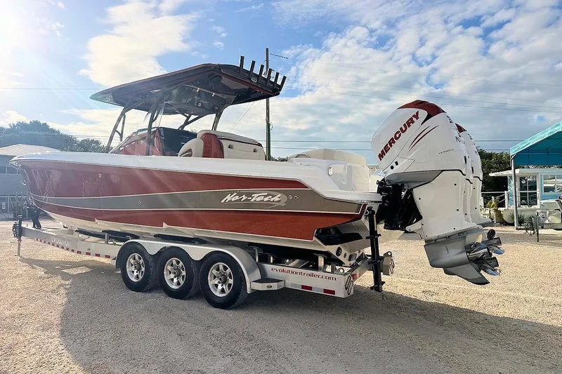 Slide: The Image of 2016 Nor-Tech 340 Sport Center Console boat with Mercury engines on a trailer. - 4