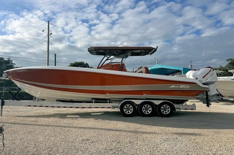 Slide: The Image of 2016 Nor-Tech 340 Sport Center Console boat on trailer, under cloudy sky. - 5