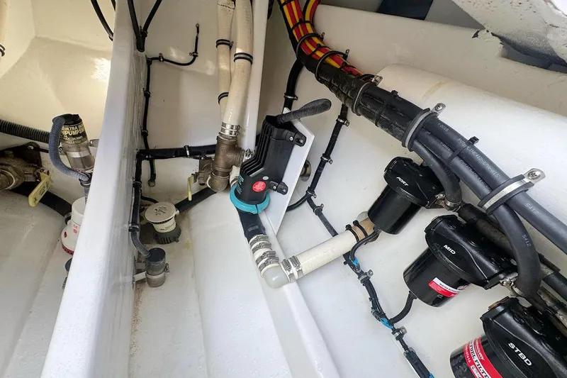 Slide: The Image of Engine compartment of a 2016 Nor-Tech 340 Sport Center Console boat, showing hoses and fittings. - 8