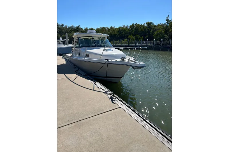 Slide: The Image of 2008 Pursuit OS 315 Offshore boat docked at marina on sunny day. - 10
