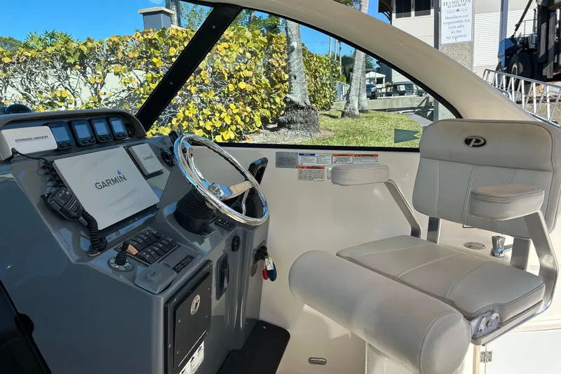 Slide: The Image of 2008 Pursuit OS 315 Offshore boat cockpit with Garmin navigation system and comfortable seating. - 11