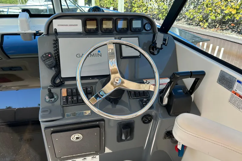 Slide: The Image of 2008 Pursuit OS 315 Offshore boat helm with Garmin navigation and control panel. - 12