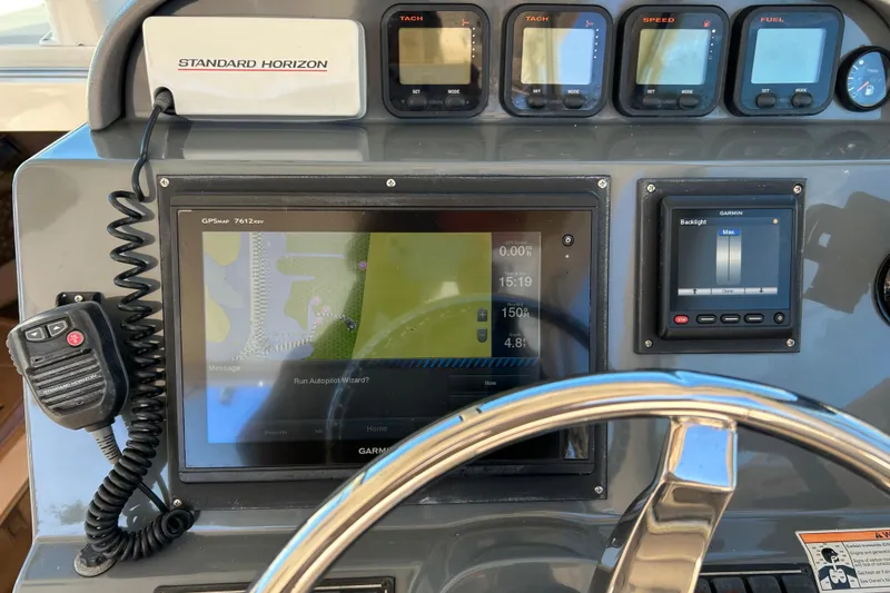 Slide: The Image of Control panel of a 2008 Pursuit OS 315 Offshore boat with navigation equipment. - 13