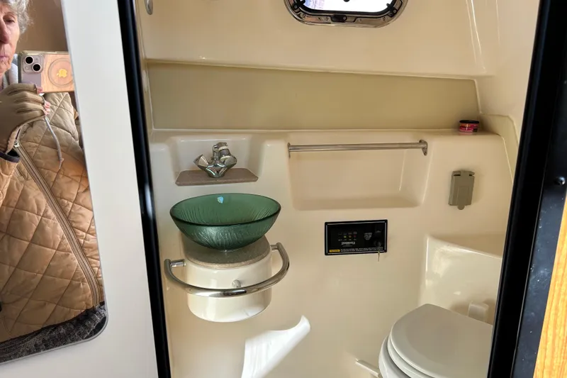 Slide: The Image of 2008 Pursuit OS 315 Offshore bathroom with glass sink and toilet. - 20