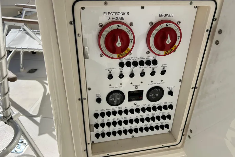 Slide: The Image of Control panel of a 2008 Pursuit OS 315 Offshore boat, featuring electronics and engine switches. - 23