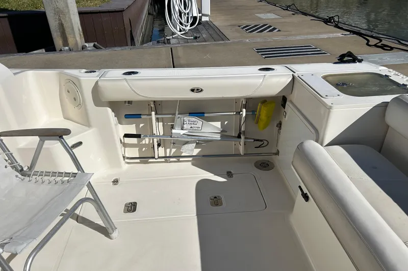 Slide: The Image of 2008 Pursuit OS 315 Offshore boat interior with seating and storage compartments. - 6