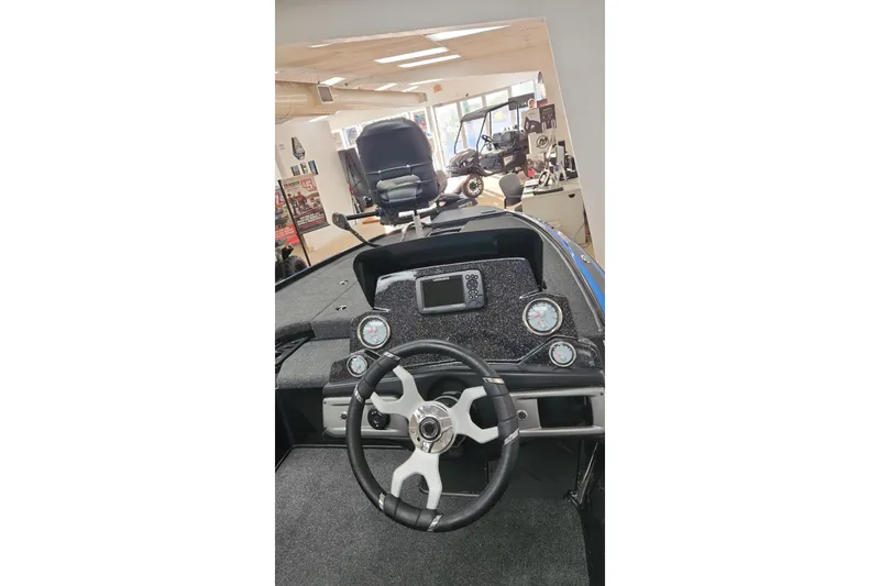 Slide: The Image of 2024 Nitro Z19 boat interior with steering wheel and dashboard controls. - 4