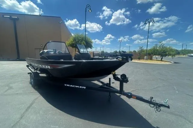 The Image of 2026 Tracker Pro Guide V-16 WT boat on trailer under blue sky. - 0