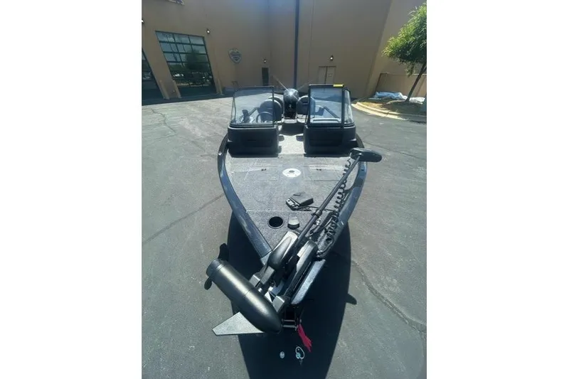 Slide: The Image of 2026 Tracker Pro Guide V-16 WT boat with dual windshields, parked outdoors. - 4
