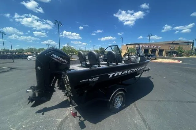 Slide: The Image of 2026 Tracker Pro Guide V-16 WT boat with Mercury engine in parking lot. - 3