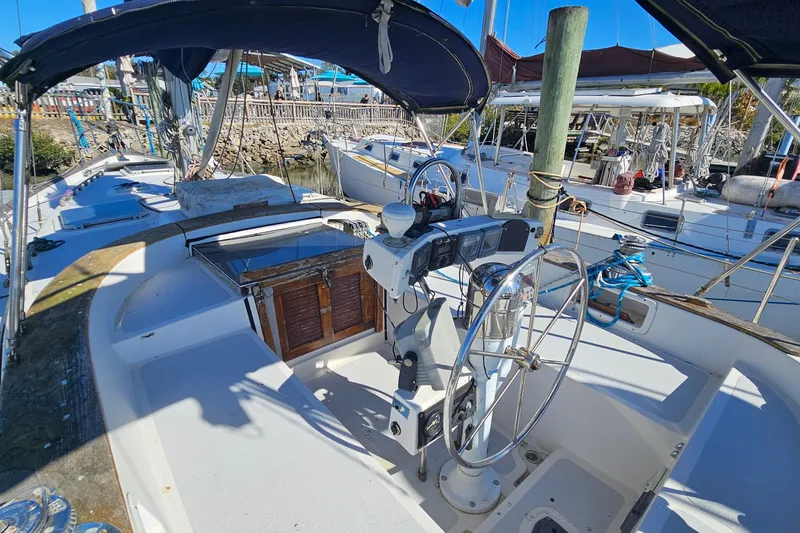 Slide: The Image of Sailboat cockpit of 1989 ENDEAVOR 42, featuring steering wheel and navigation instruments. - 10