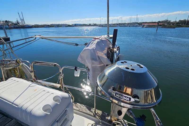 Slide: The Image of Sailboat deck with grill and cooler, Endeavor 42, 1989, docked by calm waters. - 12