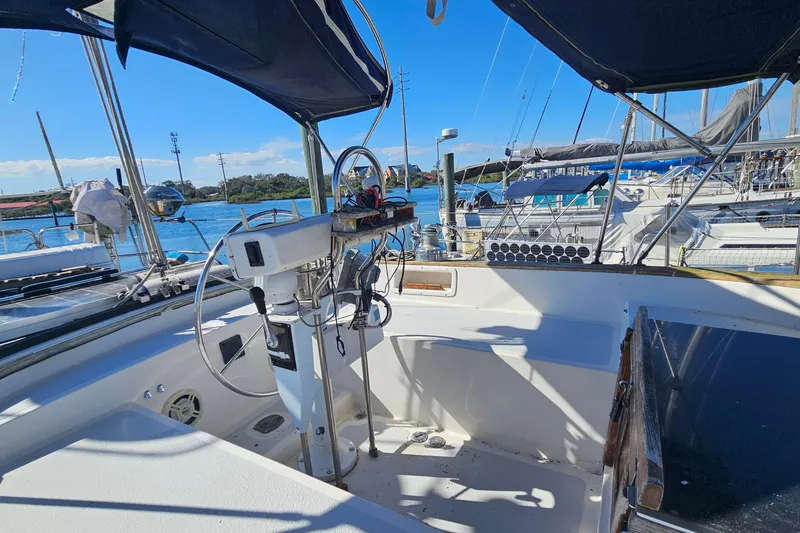 Slide: The Image of Cockpit view of 1989 ENDEAVOR 42 sailboat docked in a marina under clear blue skies. - 16