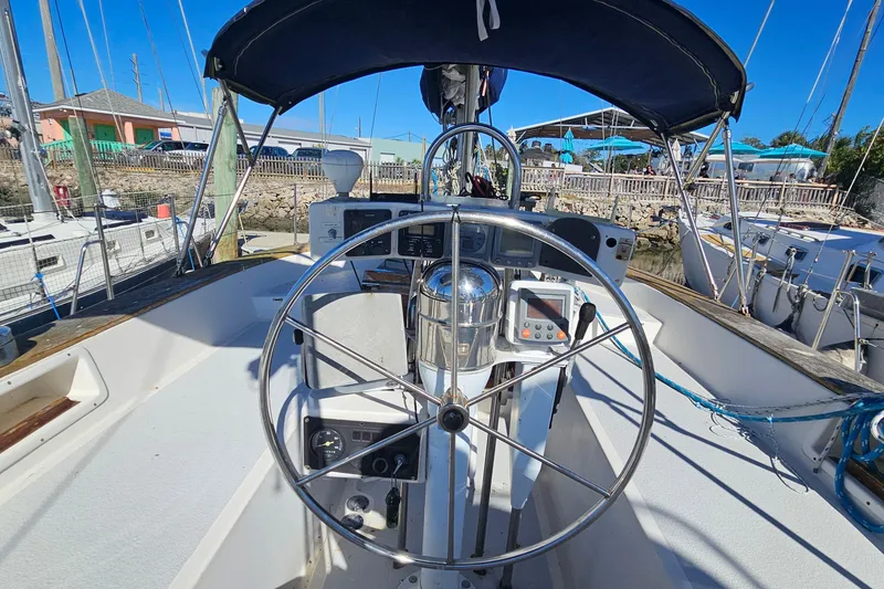 Slide: The Image of Cockpit of 1989 ENDEAVOR 42 sailboat with steering wheel and navigation instruments. - 17