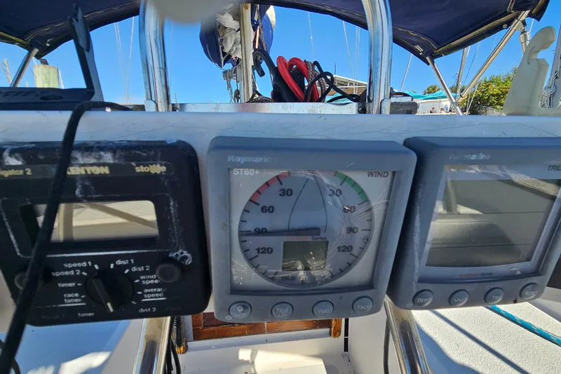 Slide: The Image of Cockpit instruments on a 1989 ENDEAVOR 42 sailboat, featuring navigation and wind gauges. - 19