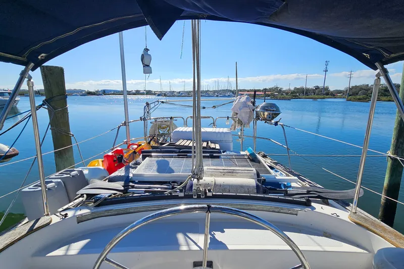 Slide: The Image of Cockpit view of 1989 ENDEAVOR 42 sailboat docked in a serene marina. - 24