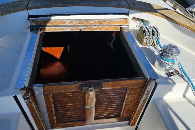 Slide: The Image of Open hatch on 1989 ENDEAVOR 42 sailboat deck, showing wooden interior and winch. - 26