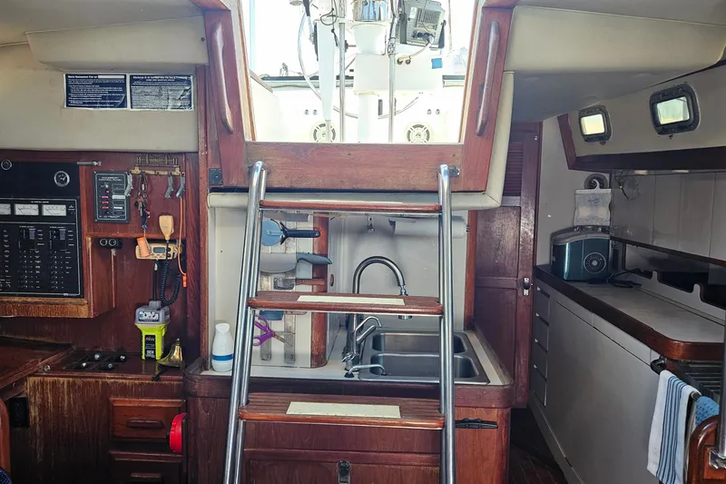 Slide: The Image of Interior of 1989 ENDEAVOR 42 sailboat with wooden cabinetry and stainless steel sink. - 28