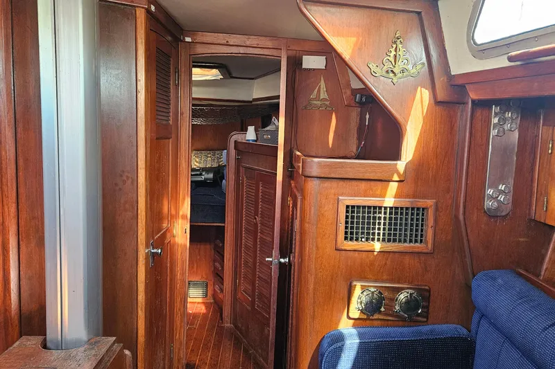 Slide: The Image of Interior of 1989 ENDEAVOR 42 sailboat with wooden paneling and nautical decor. - 31