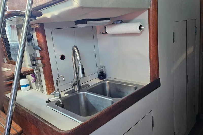 Slide: The Image of 1989 ENDEAVOR 42 yacht kitchen with dual sinks and wooden accents. - 37